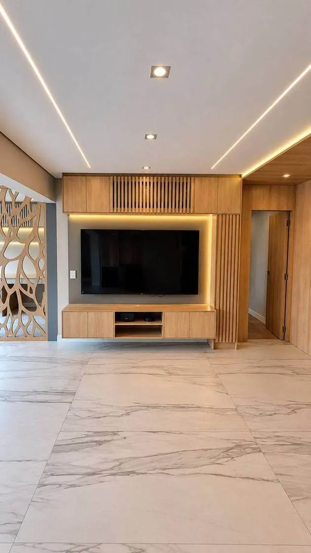 Sala de apartamento de alto padrão reformada pela Morale Arquitetura e Reforma, com marcenaria sob medida e iluminação em projeto