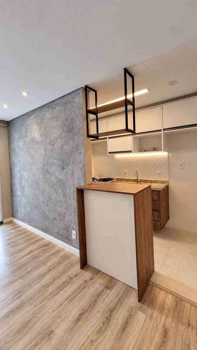 Reforma de apartamento na Chácara Santo Antônio, região de Santo Amaro, São Paulo — cozinha com ilha e cimento queimado pela Morale